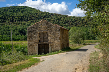 An old stone house in the forest in France.