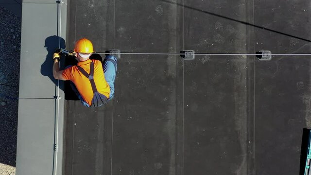 Building Roof Lightning Protection System Installation by Professional Caucasian Worker