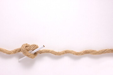 close-up of a brown strong rope, tie with smoking