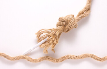 close-up of a brown strong rope, tie with smoking