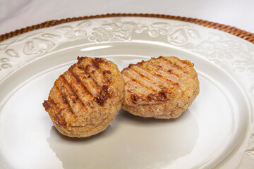 Grilled Vegetarian Dumplings on a White Plate with Embossed Edge