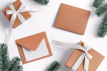 Christmas card with craft gifts, letters and green fir twigs.