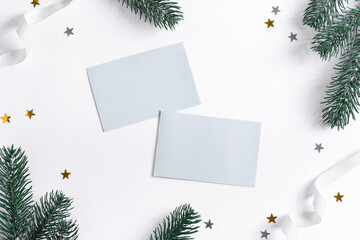 Fototapeta na wymiar Christmas card with fir twigs, confetti and mockup letter.