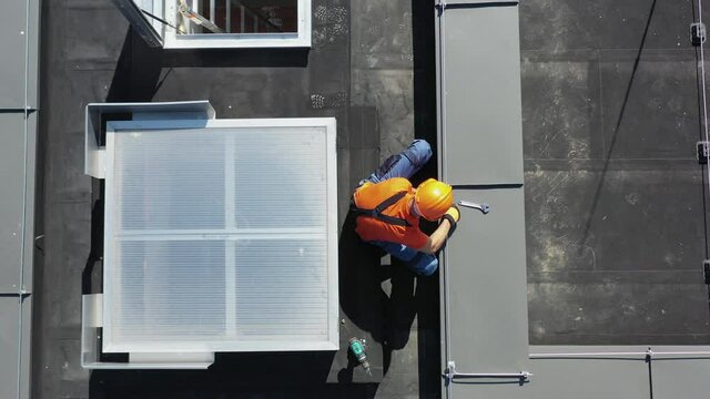 Assembling Lightning Protection System on Building Roof by Caucasian Technician in His 40s