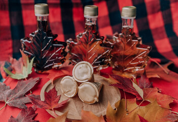 Maple syrup bottles and taffy cones traditional sweet gift and dessert from local sugar shack in...