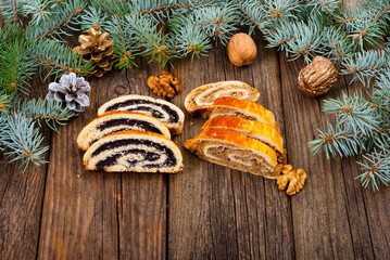 poppy and walnut roll cakes, pine branch, old wood table