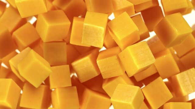 Super Slow Motion Shot of Flying Cheddar Cheese Cubes at 1000 fps.