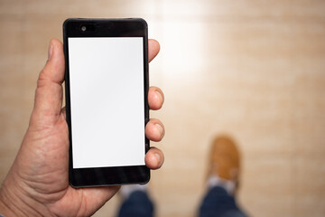 subjective view of man holding a smart-phone at home