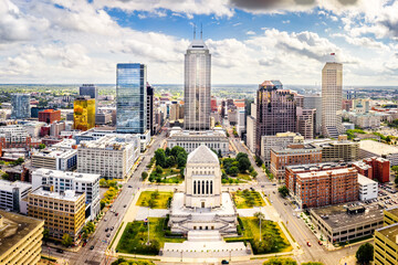 Aerial view of Indianapolis, Indiana skyline above Indiana World War Memorial and University park, and along Meridian and Pennsylvania streets. - 385827088