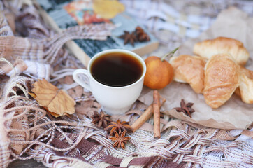 Fresh croissants with cream and hot coffee. Autumn composition.