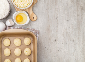 Uncooked typical brazilian cheese breads with ingredients and copy space
