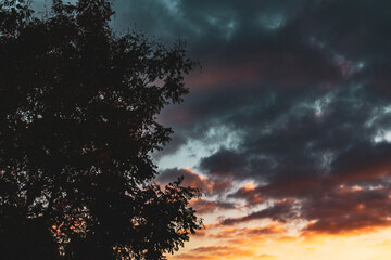 Fototapeta na wymiar Fiery sunset in the sky, the beginning of the night