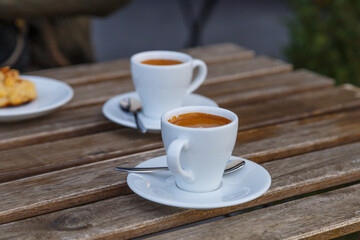 Cup of coffee on table in coffee shop cafe.A cup of coffee and coffee beans with croissant on the table