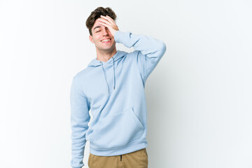 Fototapeta premium Young caucasian man isolated on white background laughing happy, carefree, natural emotion.