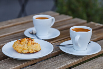 Cup of coffee on table in coffee shop cafe.A cup of coffee and coffee beans with croissant on the table