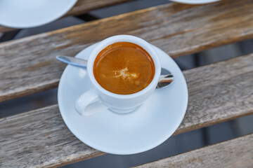 Cup of coffee on table in coffee shop cafe.A cup of coffee and coffee beans with croissant on the table