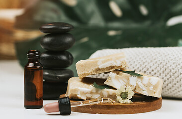 handmade soap made from squeezing soap slivers, pyramid of stones and oil, the concept of spa and self-care at home