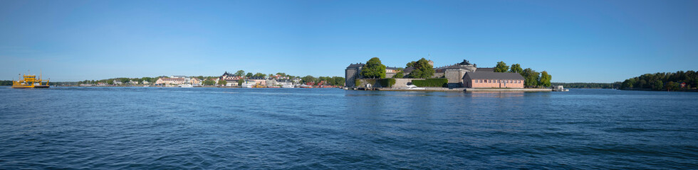 Panorama view over the islands Vax&ouml;n, Vaxholmen and Rind&ouml;. An old castle, car ferries and commuter boats to the Stockholm archipelago.