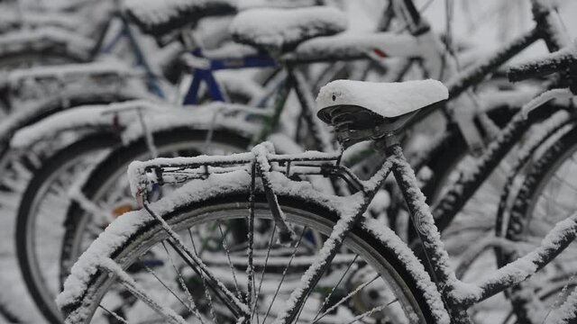 snow covered bikes in the parking lot, Finland