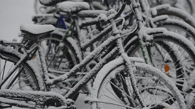 snow covered bikes in the parking lot, Finland