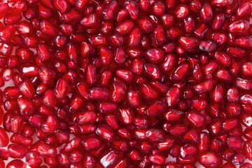 Pomegranate seeds close up. Background for wallpaper, banner, postcard, packaging