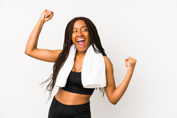 Naklejka na ściany i meble Young african american sport woman isolated raising fist after a victory, winner concept.
