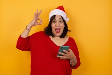 Portrait of a pretty happy Caucasian girl taking a selfie isolated over bright background