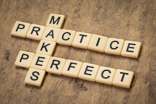 practice makes perfect crossword in ivory letters against textured bark paper, education and training concept