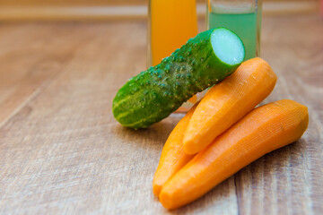 cucumbers and carrots. Healthy food, healthy drink. healthy eating for breakfast. Wood background. Peeled vegetables on a cutting board