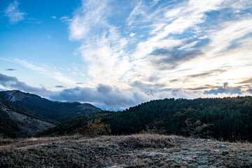sunrise in the mountains with morning fog from early autumn