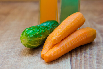 cucumbers and carrots. Healthy food, healthy drink. healthy eating for breakfast. Wood background. Peeled vegetables on a cutting board