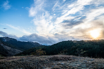 sunrise in the mountains with morning fog from early autumn