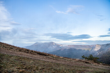 sunrise in the mountains with morning fog from early autumn