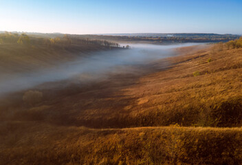 Fototapeta na wymiar Aerial view to foggy valley autumn season