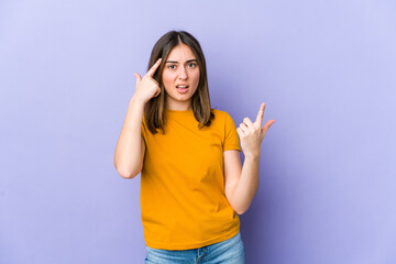 Young caucasian woman showing a disappointment gesture with forefinger.