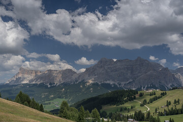 View of the magnificent Dolomite mountains as seen from Piz La Ila plateau above La Villa village in Badia valley, Dolomites, South Tirol, Italy. 