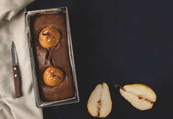 Homemade vegan chocolate cake with poached pears. Top view, flat lay.