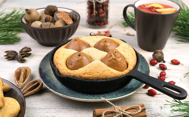 Fruit pie in shape on a blue plate on a Christmas background. Side view. The concept of New year and Christmas.