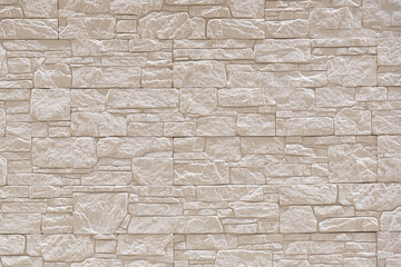 Fragment of a wall tiled with masonry tiles. Background. Texture.