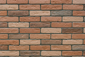 Fragment of a wall with tiles in the form of brickwork. Background. Texture.