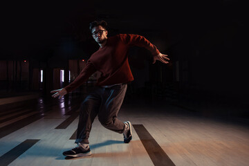 Professional break dancer posing in motion, practicing modern hip-hop dance in the studio