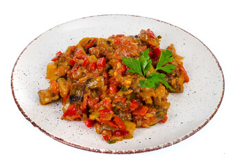 Vegetable saute of seasonal vegetables, eggplant with tomatoes on a plate, vegetarian snacks