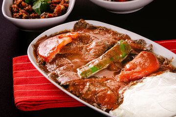 Turkish Traditional İskender Doner Kebab with butter, tomato sauce and yoghurt
