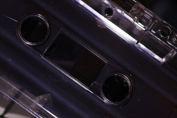 Fototapeta Audio cassette - in a dark light, against the background of a tape recorder. obraz