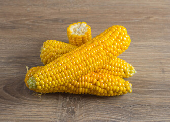Corn lies on canvas. A new crop. Corn cob on a plate. Sweet corn on background for food ingredients and cooking concept.