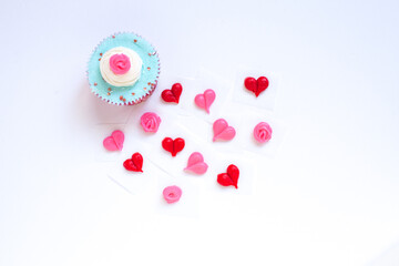 Valentine's Day Cupcakes with Blue Icing with Hearts and Pink Flower Decorations