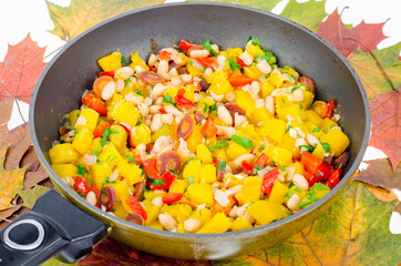 Frying pan with vegetable stew with pumpkin and white beans