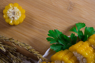Corn lies on canvas. Fresh corn closeup. Corn cob on a plate. Sweet corn on background for food ingredients and cooking concept.