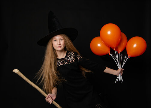 Cute teenage girl on black background with balloons on Helluin
