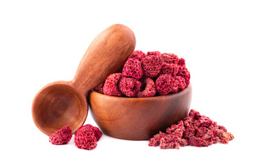 Dried raspberry isolated on white background. Dehydrated raspberry in wooden bowl and spoon.